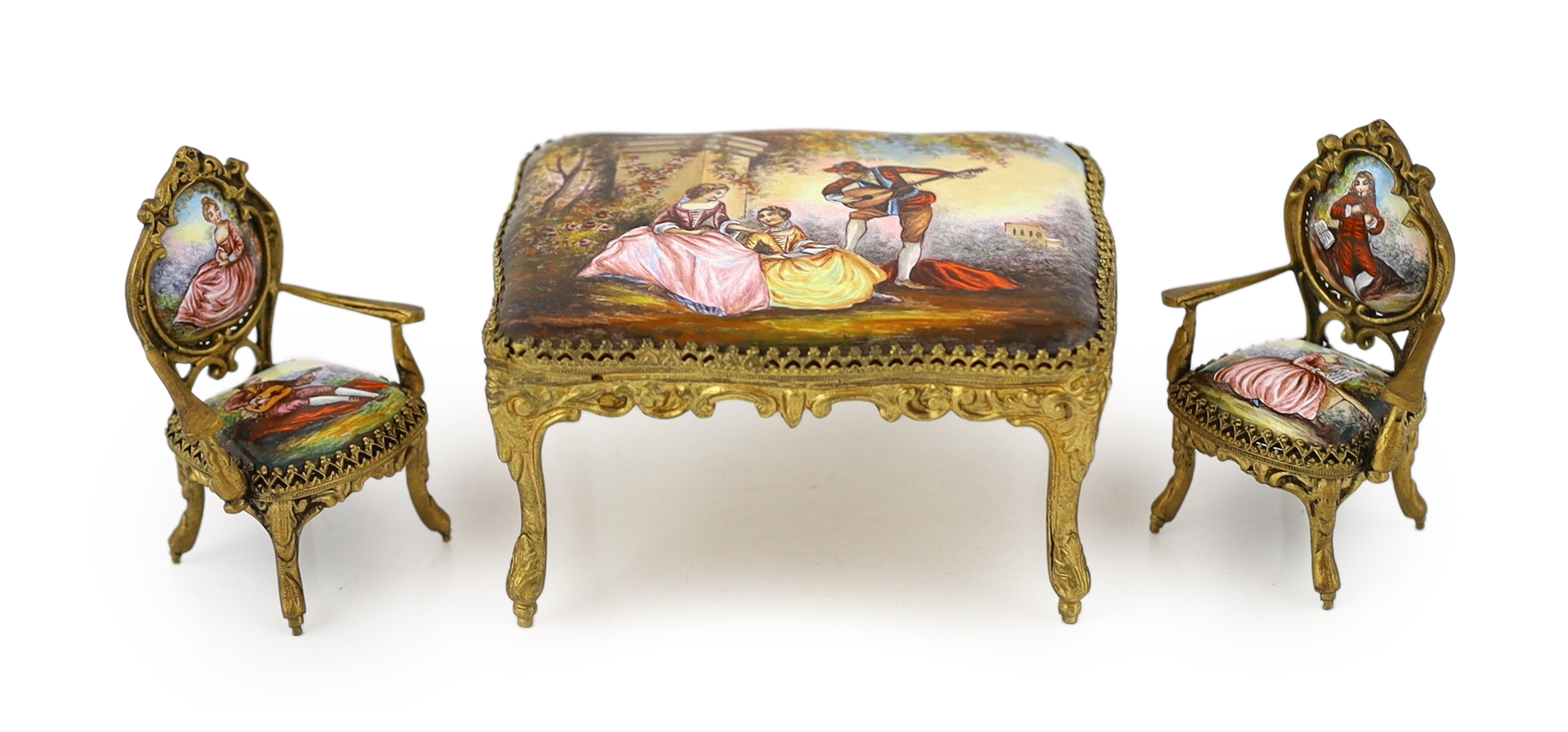 A 20th century Swiss enamel and ormolu musical miniature doll's house table with a pair of matching salon chairs, table 9.5 x 7.5cm, 5cm high, chairs 7cm high